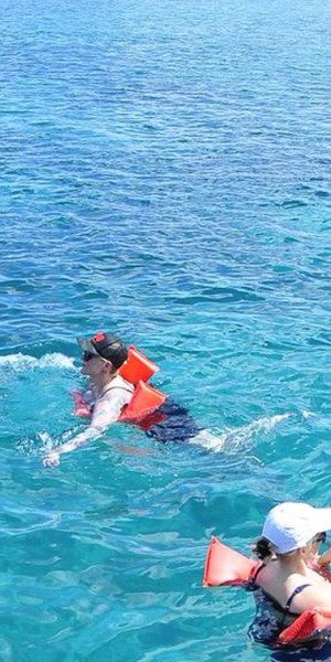 Family snorkeling together in turquoise waters in Punta Cana